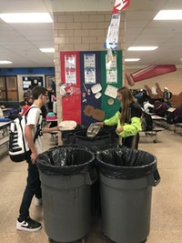 Kenwood students disposing of their lunch waste in the new environmentally friendly way of composting.