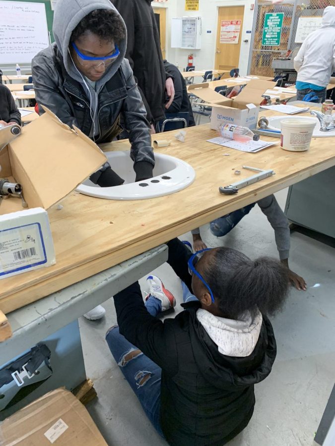 Kenwood Plumbing students installing a sink in class (pic taken prior to the pandemic). 