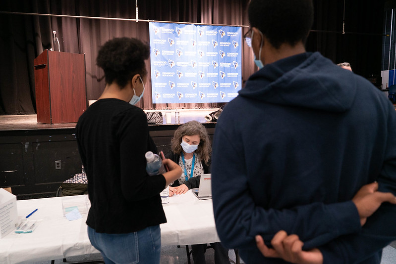 Students and families getting their first dose of the  COVID-19 vaccine in Kenwoods auditorium on May 12. 