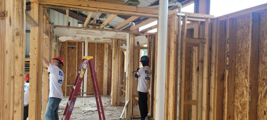 Carpentry students working on their job site behind Kenwood. 