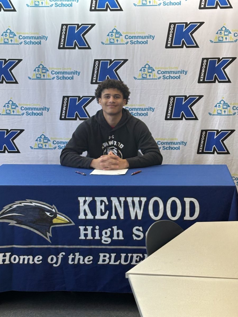 Mo Kelly signing his letter of intent to play soccer in college. 